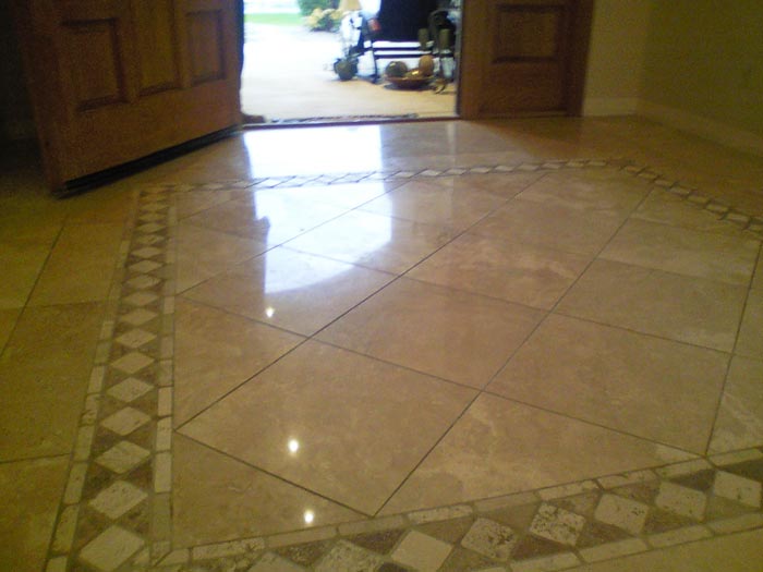 Travertine polished tile floor in home entrance