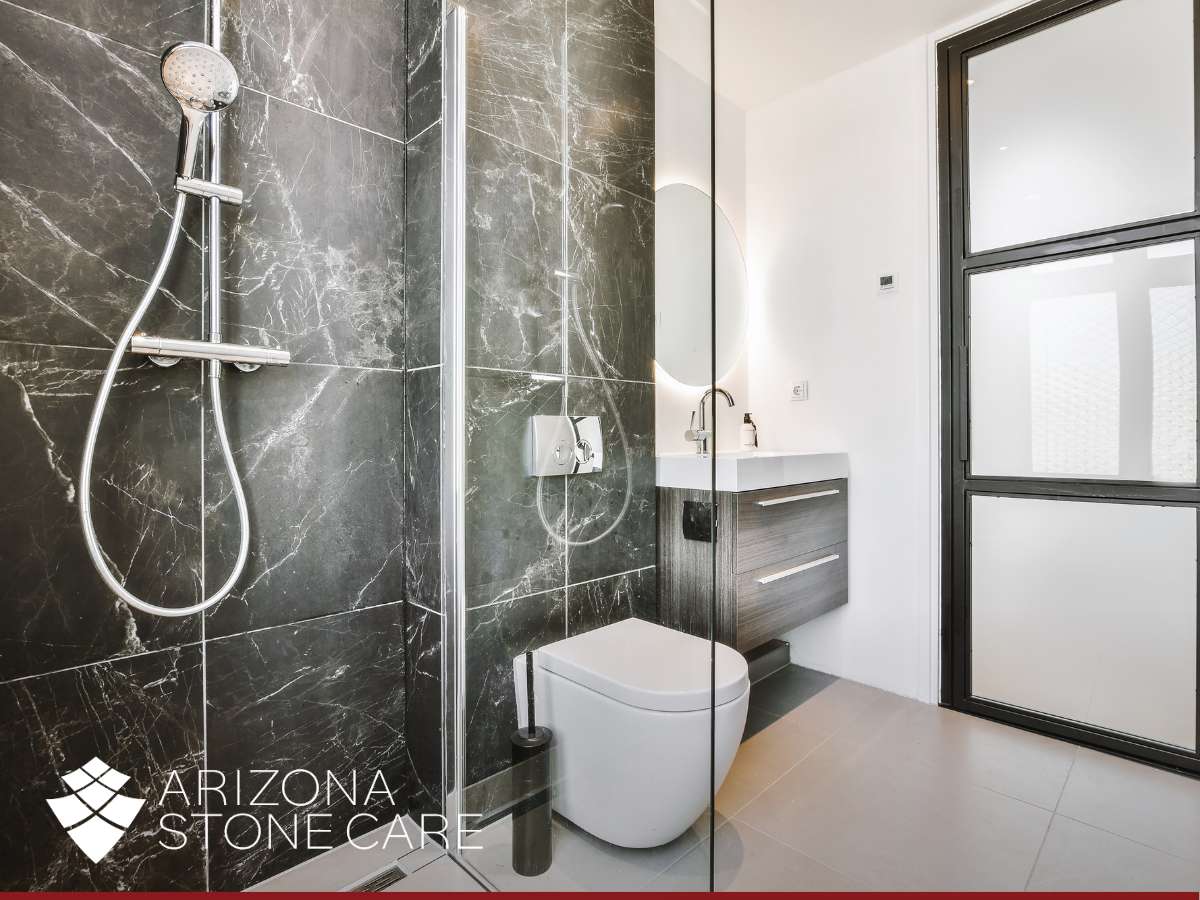 Modern bathroom with black marble shower, highlighting the importance of marble shower sealing for durability and beauty