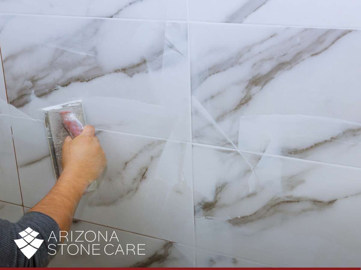 Applying grout coloring services to refresh marble tile appearance