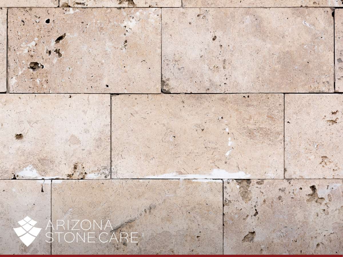 Travertine wall with natural texture, pores, and signs of wear