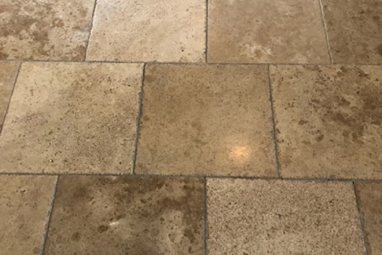 Close-up of natural travertine tile floor cleaned and restored by Arizona Stone Care commercial services